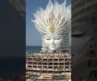 A girl’s face in the sea—the inspiration for a tattoo-themed building. #usa #music #art